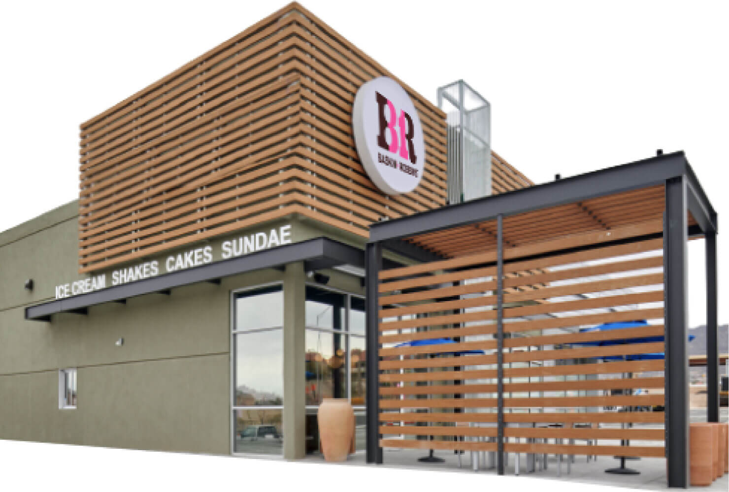 Exterior view of a baskin-robbins ice cream shop, featuring a modern design with a wooden slat facade and a covered outdoor seating area.